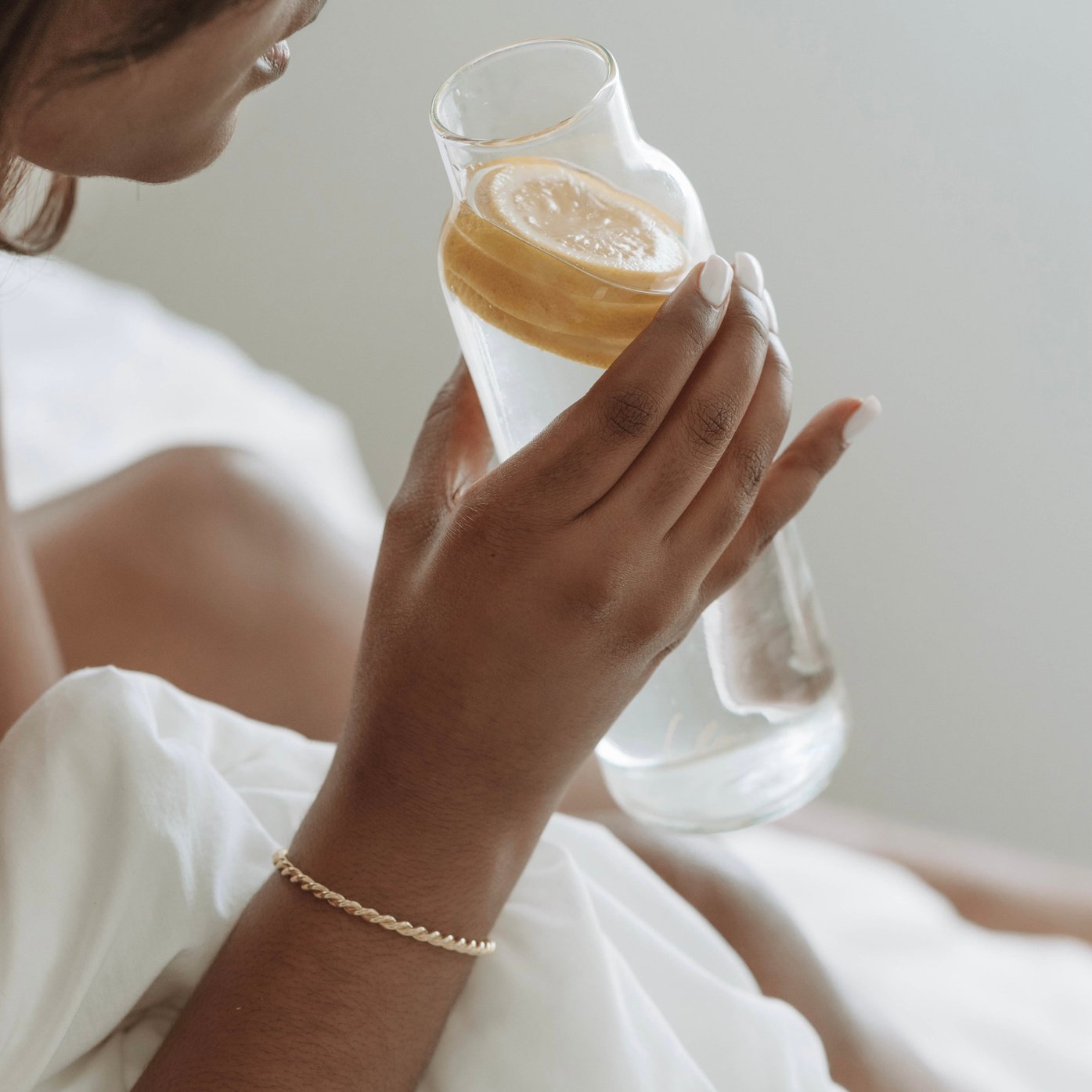 Woman drinking water with lemon 