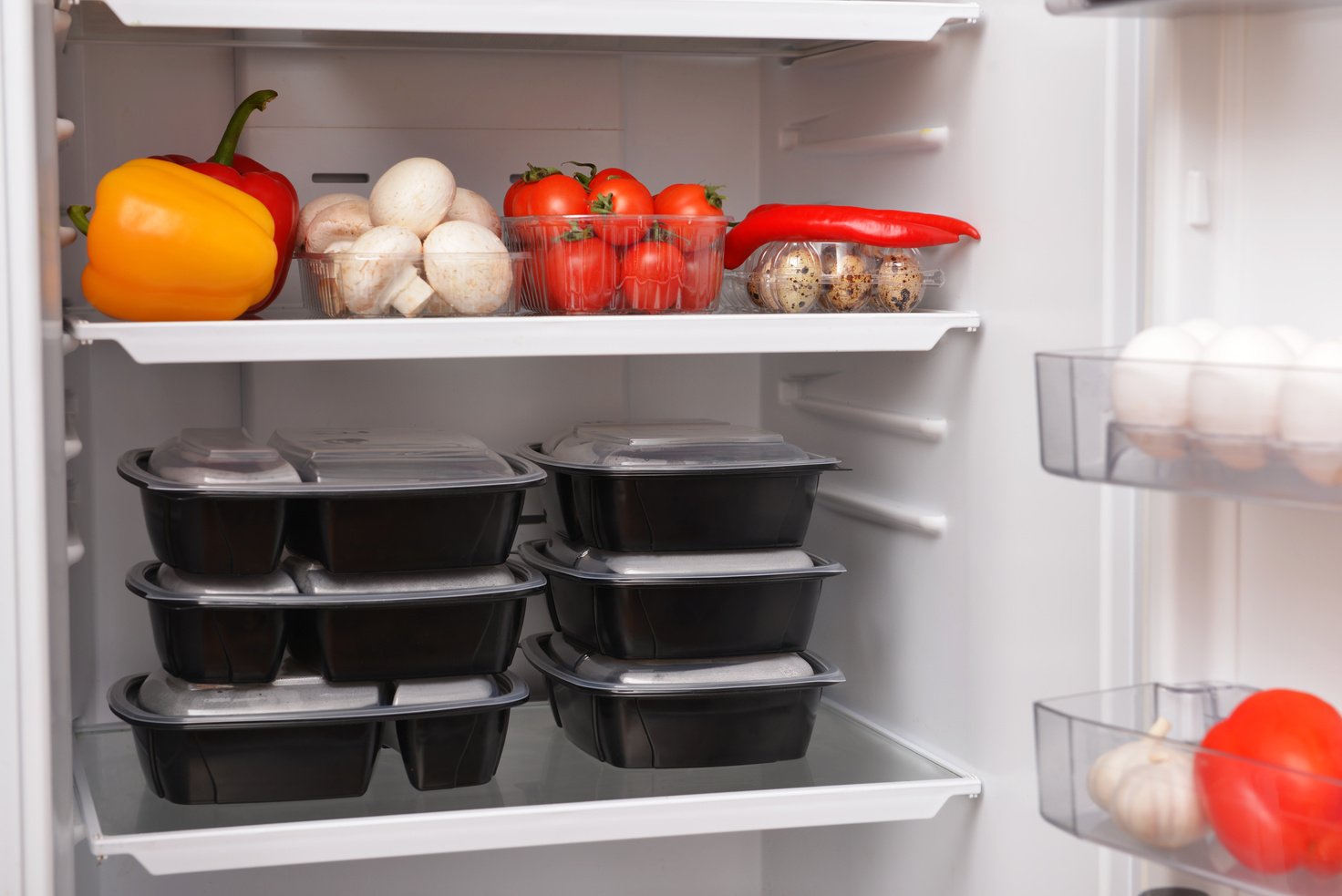 Containers with Healthy Food on Shelf in Fridge