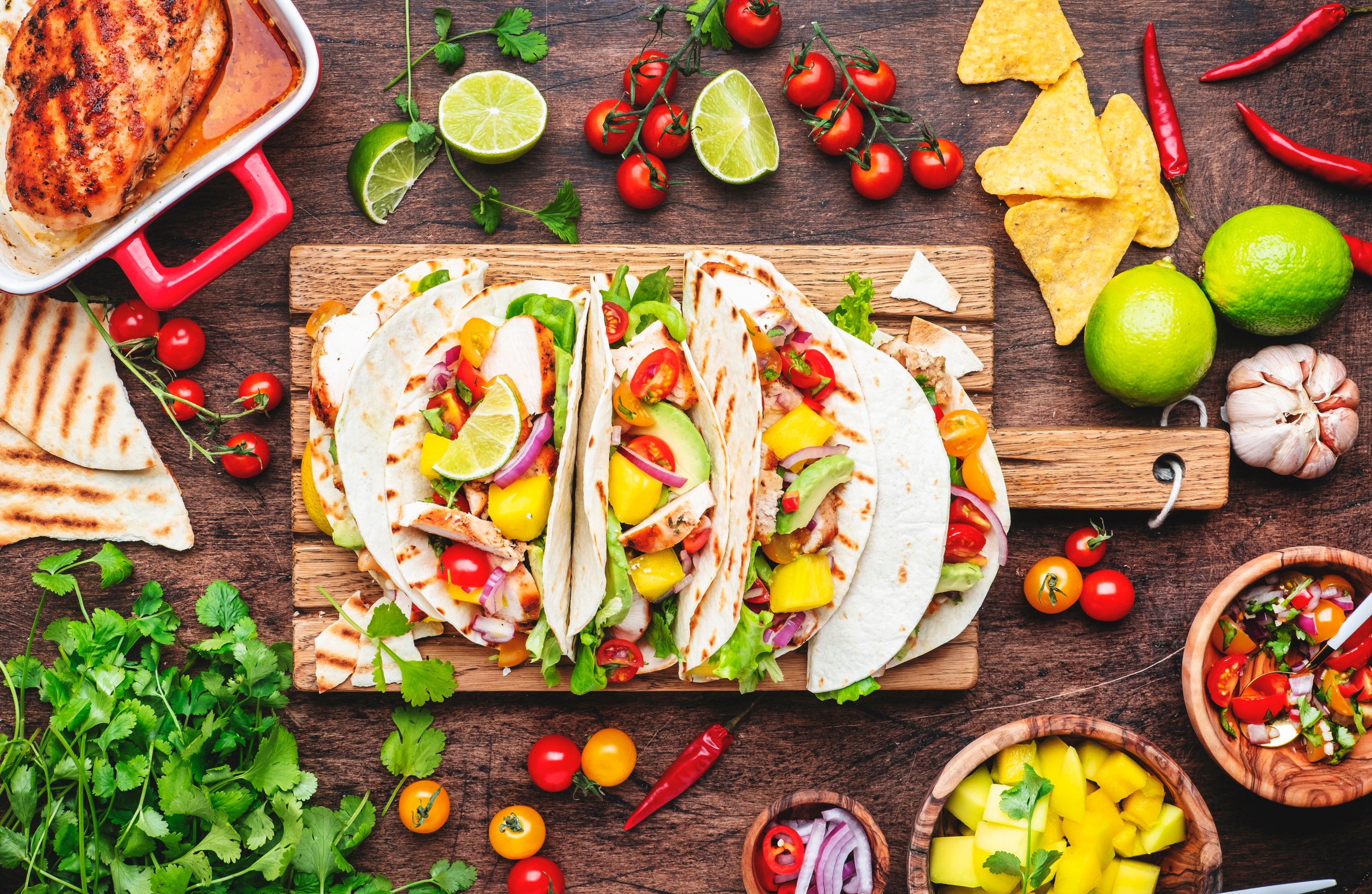 Tacos with grilled chicken, tomato salsa sauce, mango, cilantro